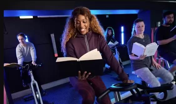 People reading books on exercise bikes