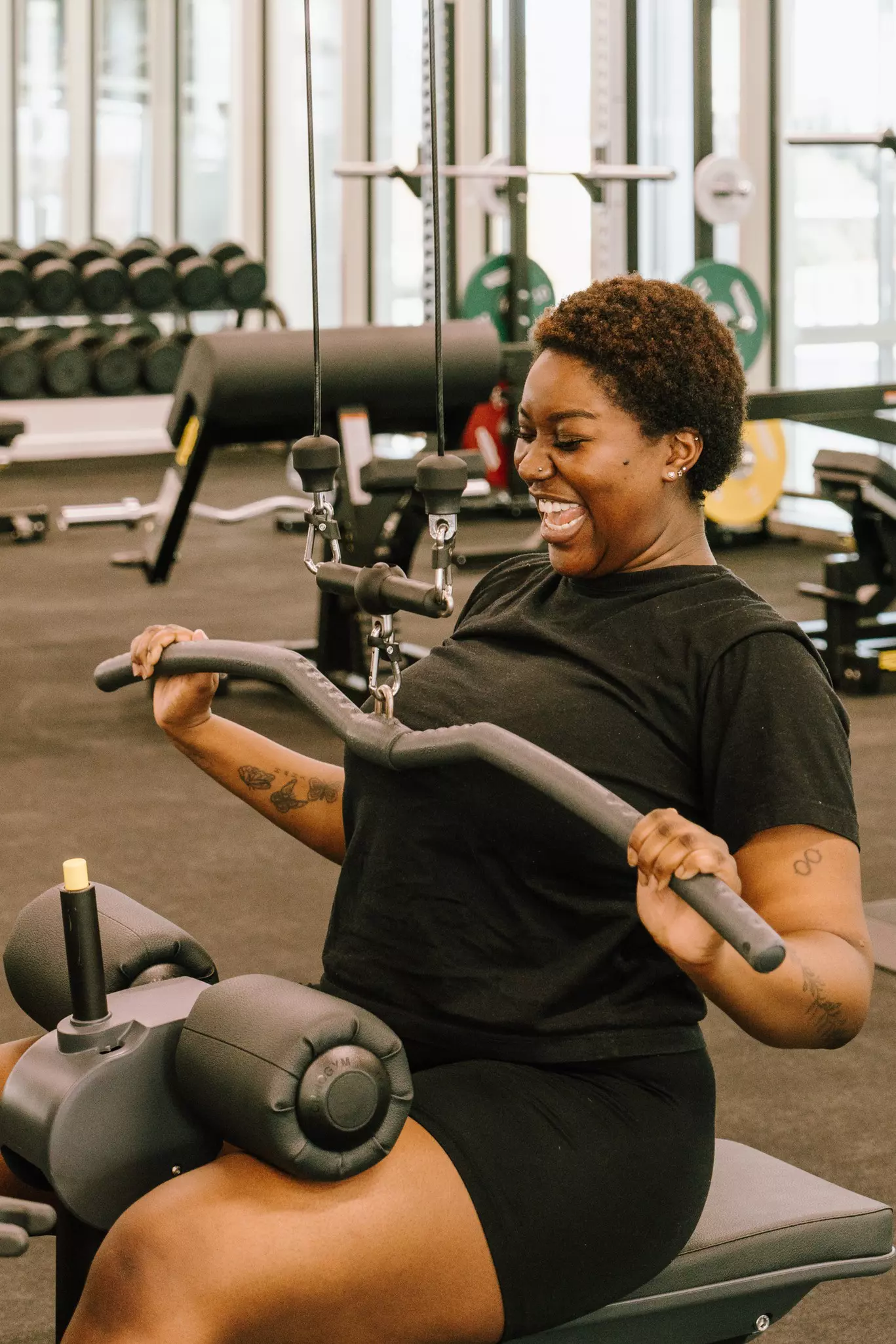 Woman on lat pulldown machine