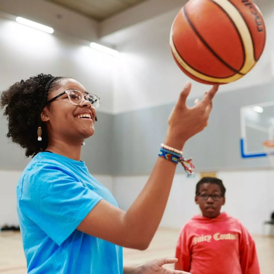 Woman holding basketball.