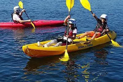 Two children on a yellow sit on top kayak