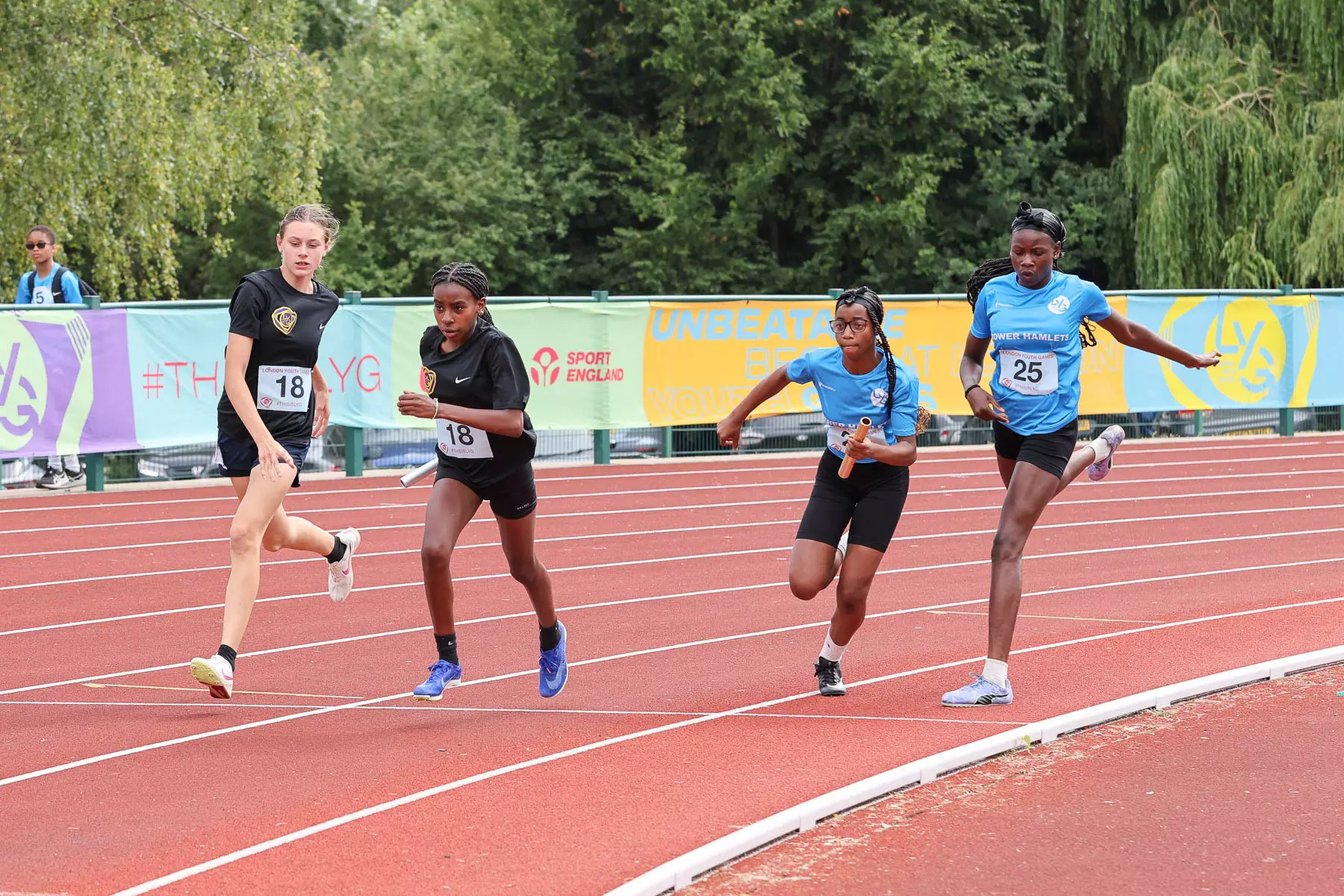 Young people running on the athletic track.