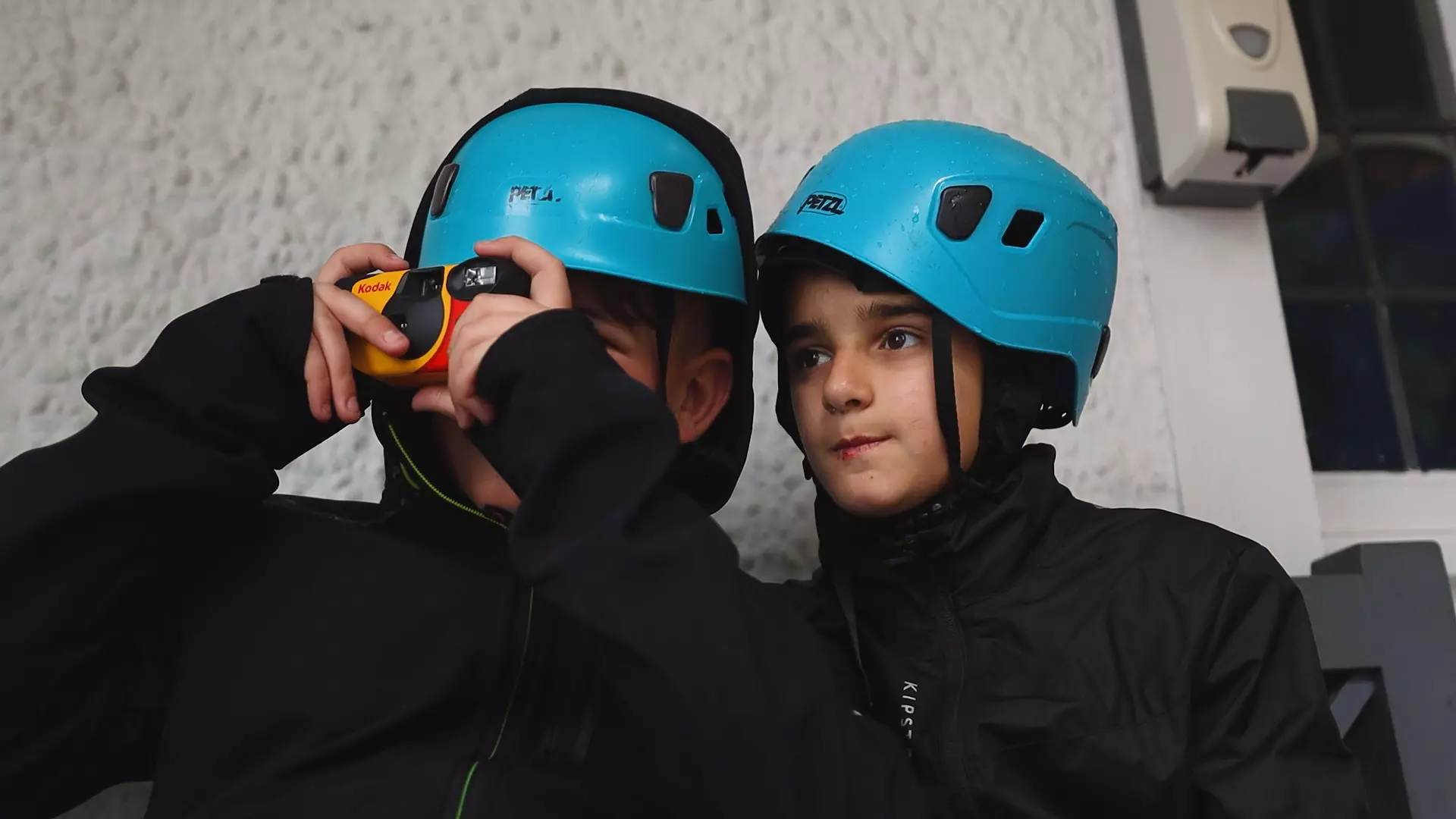 Children waiting in line wearing hard hats