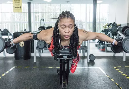 Woman on bench doing dumbbell flys