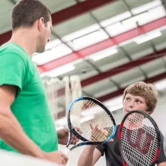 Boy being taught tennis