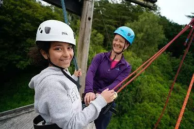 Girl and instructor on the zip line platform