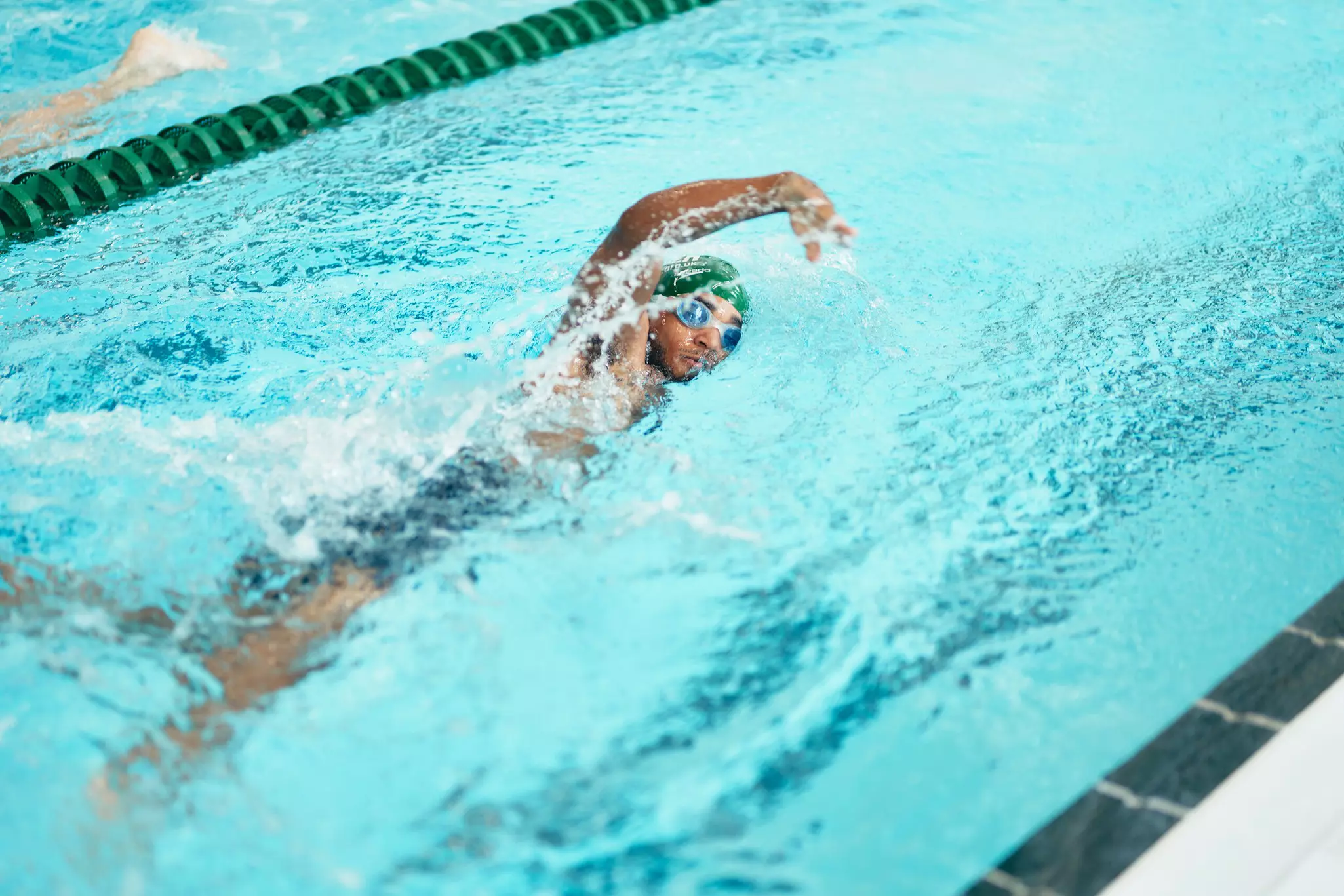 Man swimming in the indoor pool.