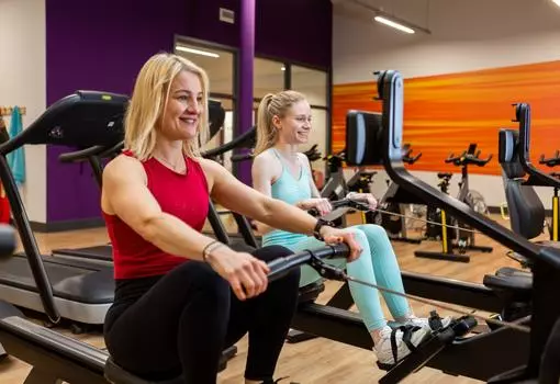 Two women on rowing machines