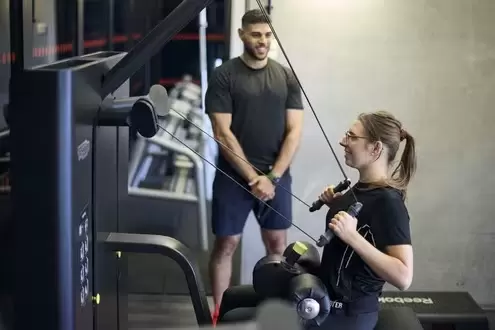 woman and PT working out in gym