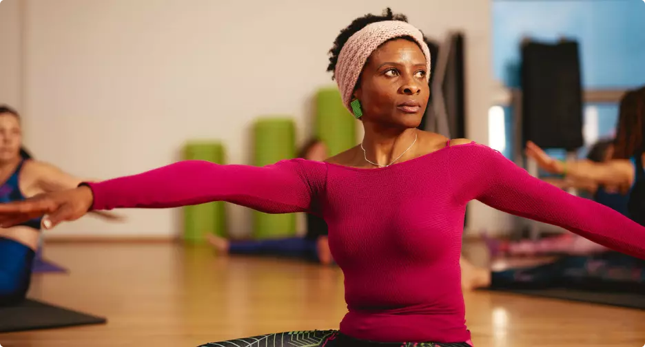 Woman stretching during a group fitness class.