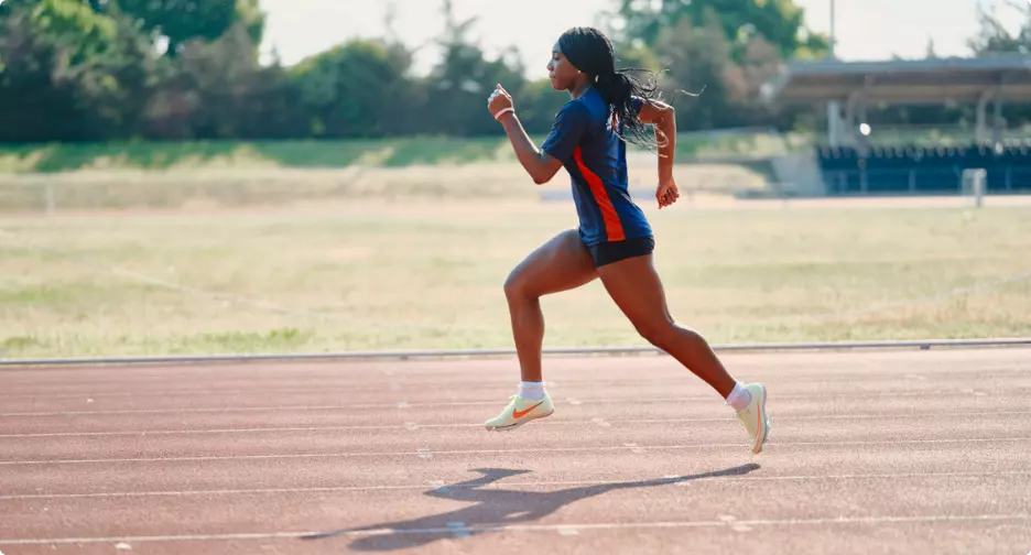 Athlete sprinting on a running track.