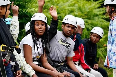 Children waiting in line wearing hard hats