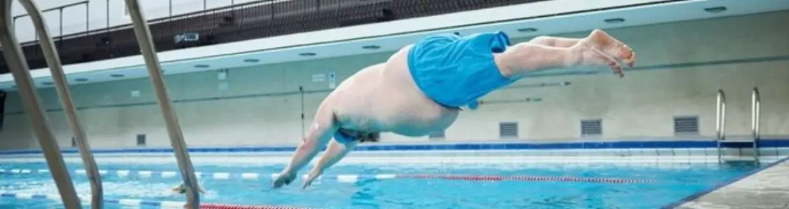 Man diving into the swimming pool.