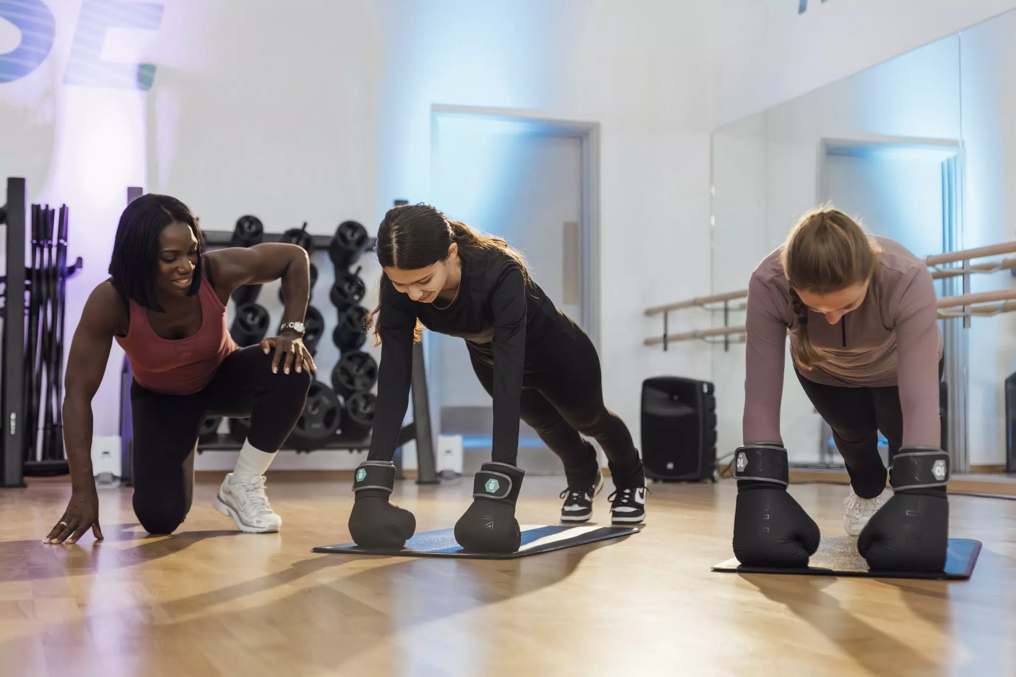 Instructor guiding teenagers in a fitness class