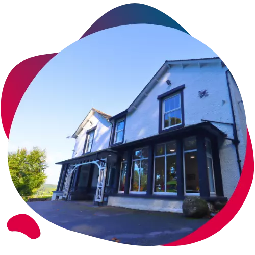 Front view of a large white house with black trim.