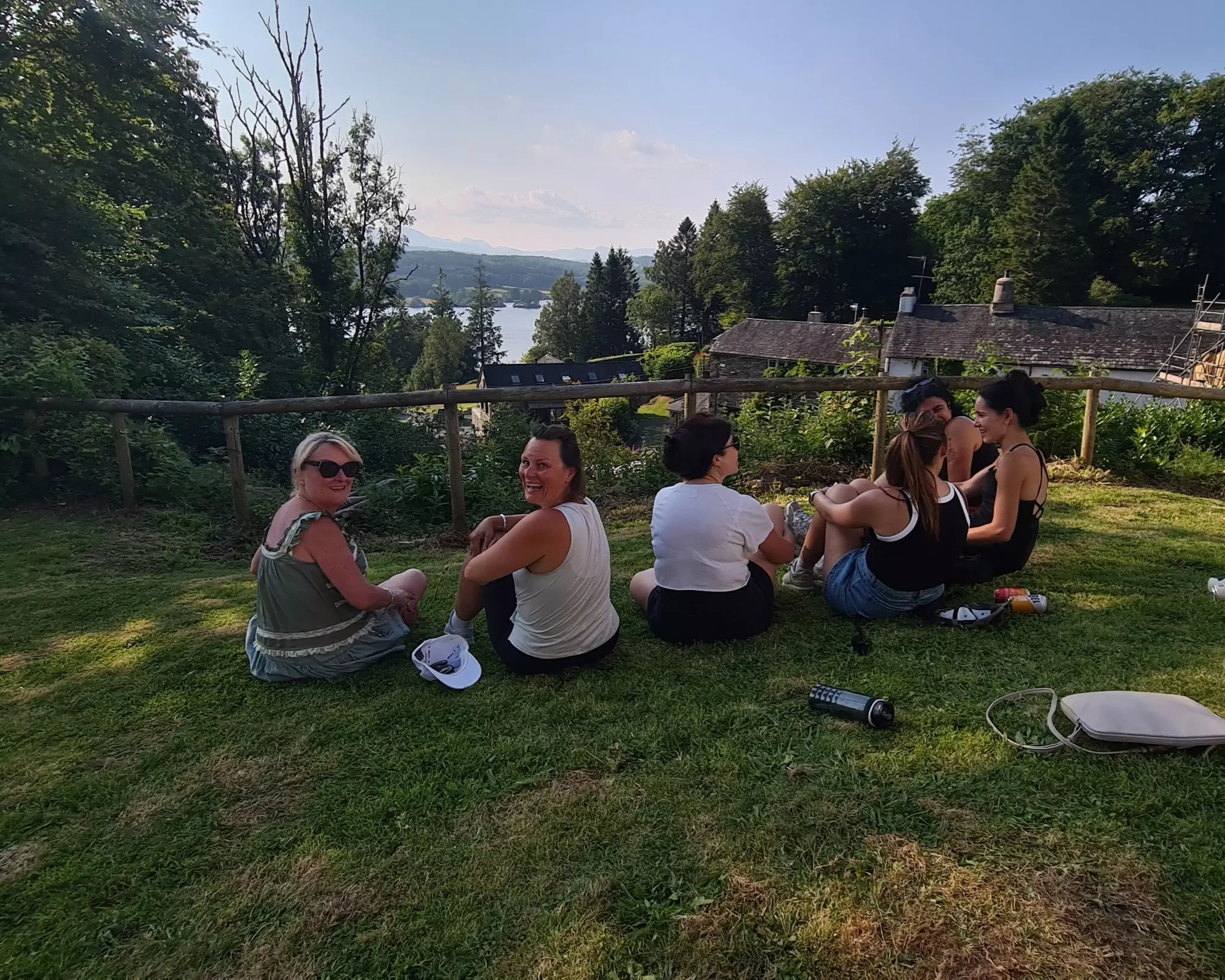 Team sitting down looking out on a beautiful lakeside view.