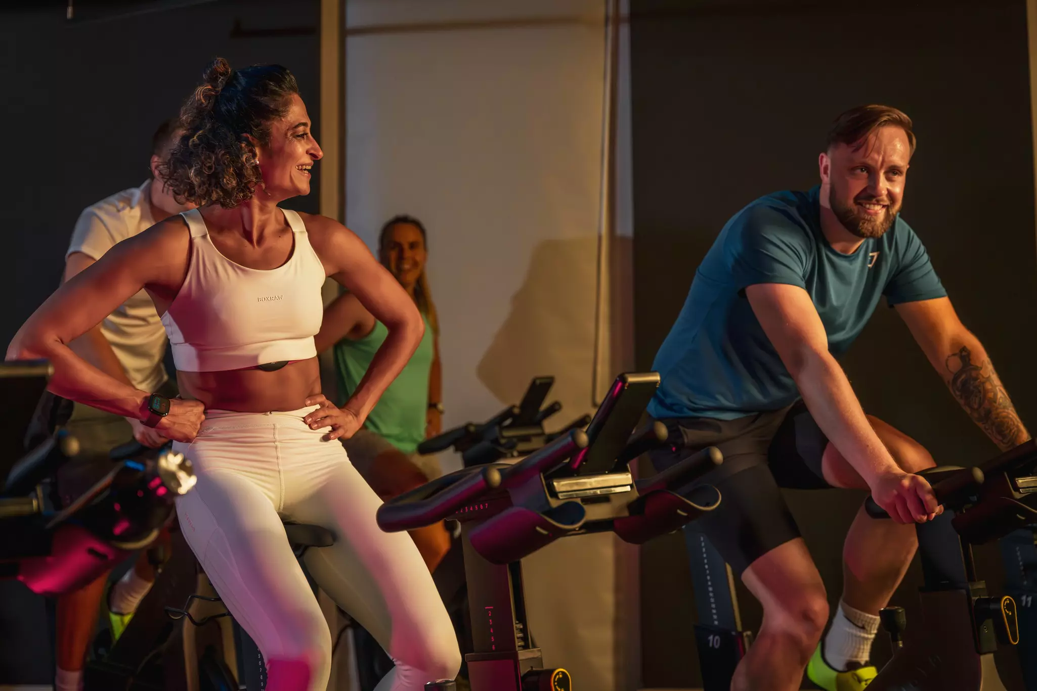 Woman and man on bikes in an elevate class