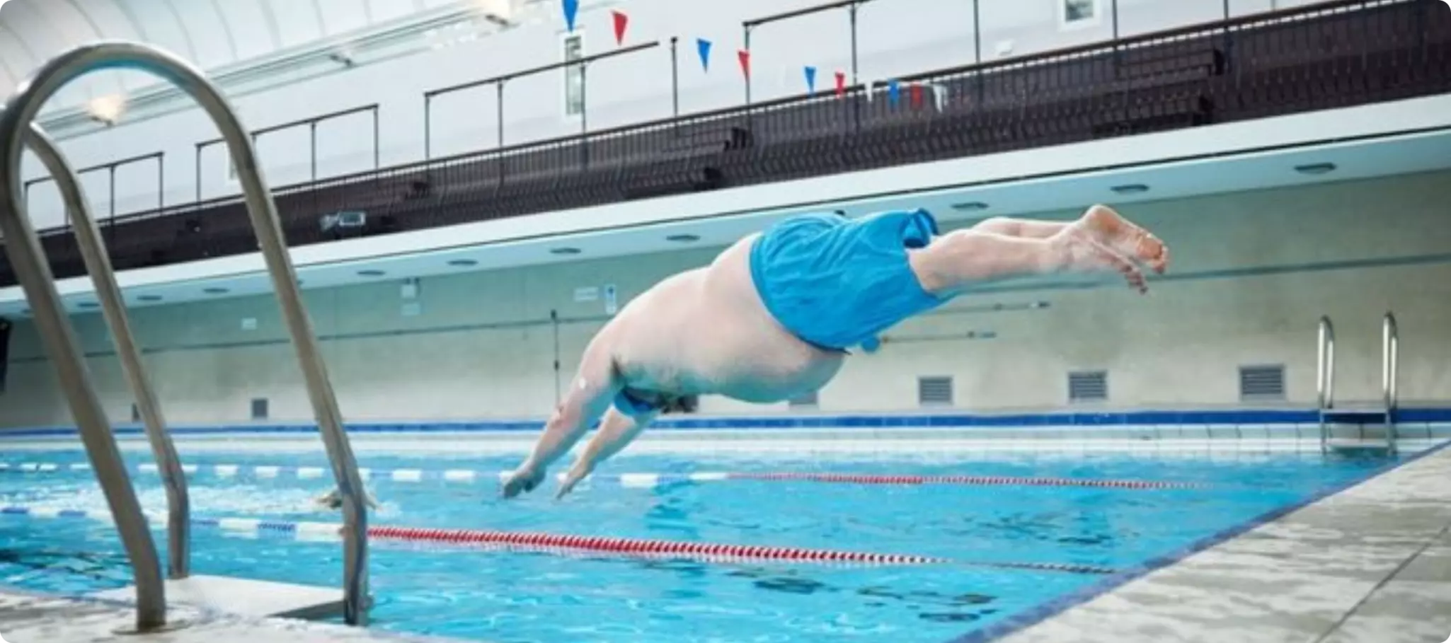 Man diving into the swimming pool.