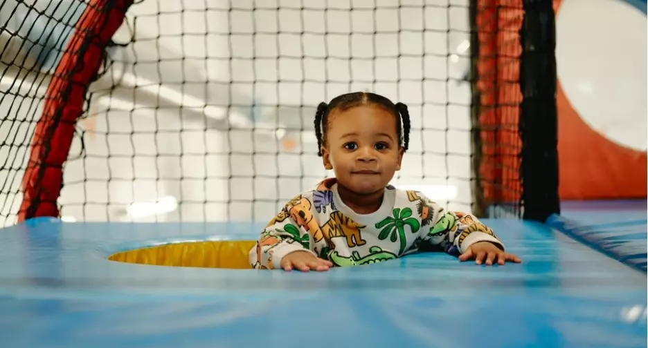 Toddler playing in a soft play area.