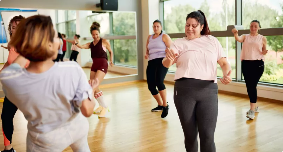 Women taking part in a group dance fitness class.