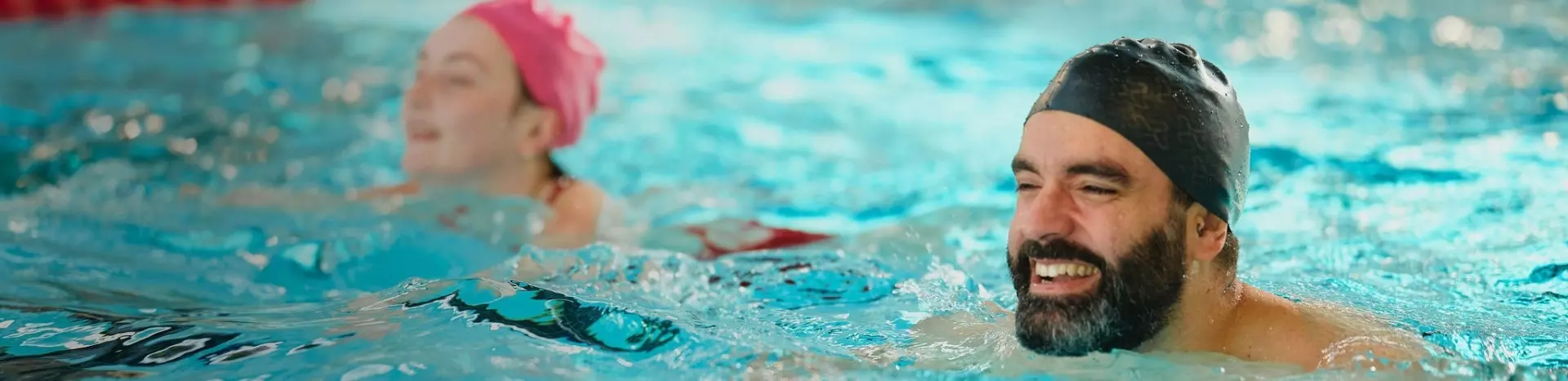 Man and woman swimming in the pool.