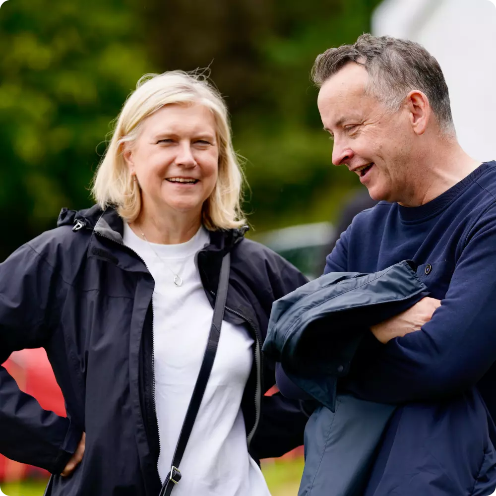 Adults laughing during outdoor event at Ghyll Head.