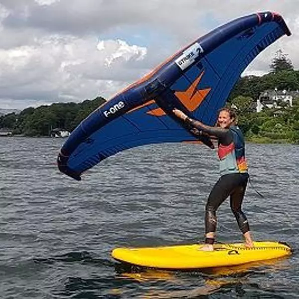Woman wingsurfing on a lake
