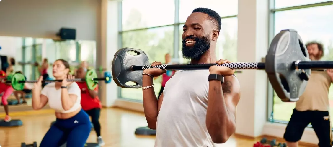 Family smiling in the pool.