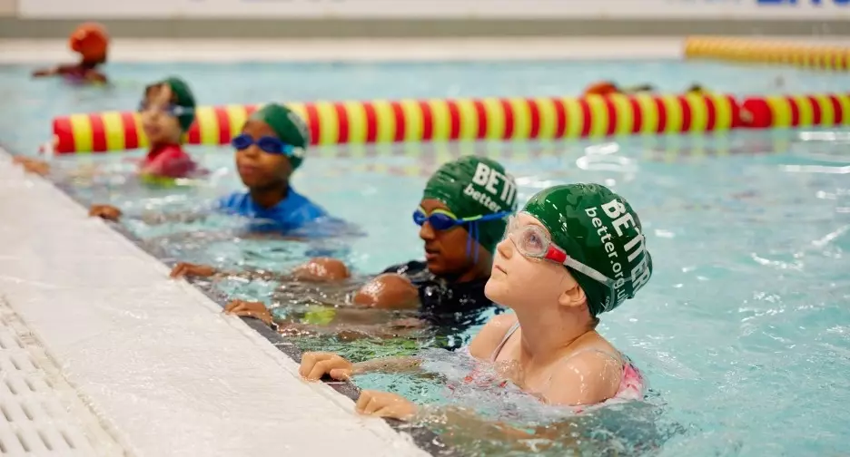 Children in the pool during swimming lesson.