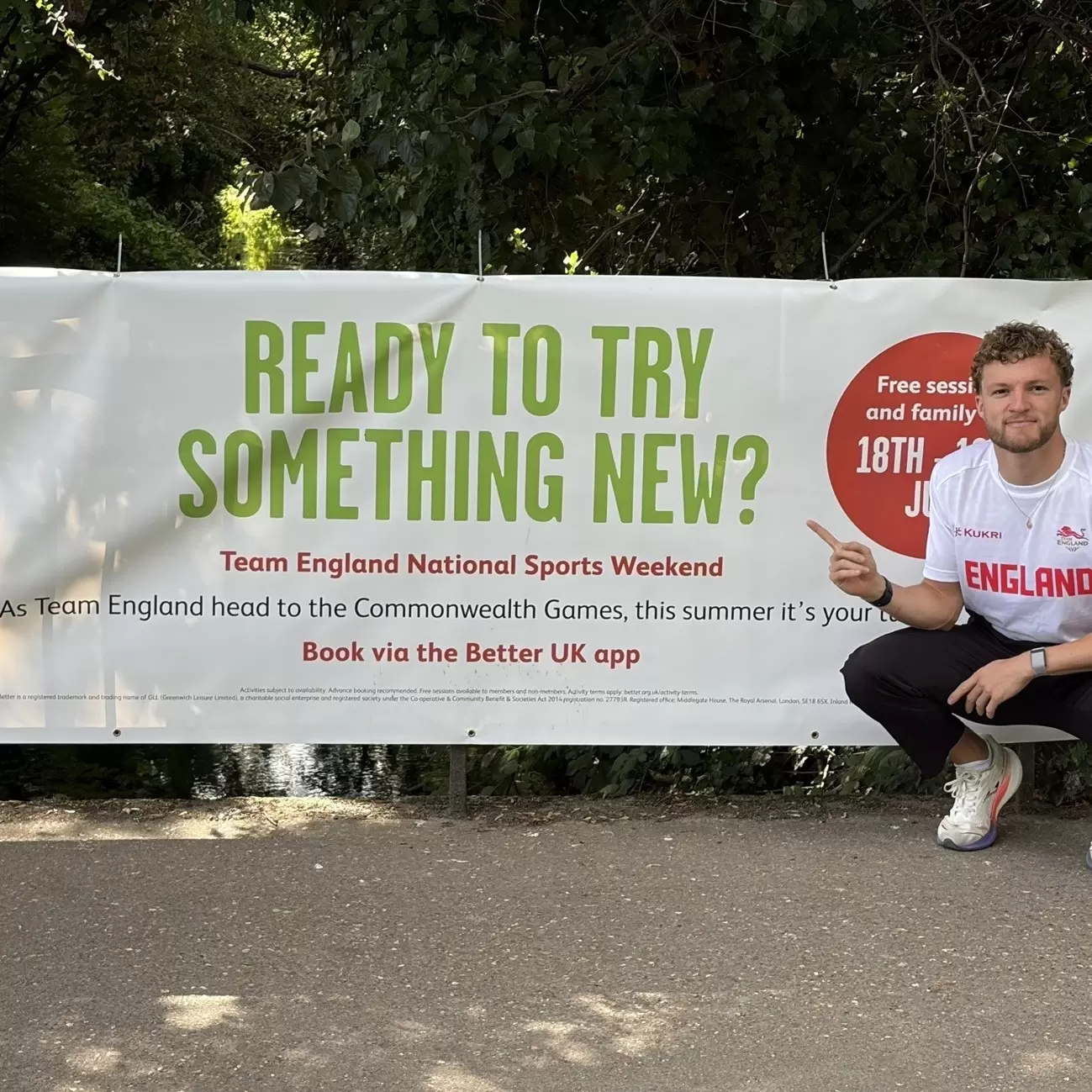 Man posing with banner